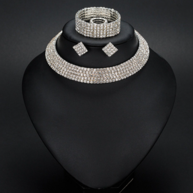 Ruby oval pendant necklace on a crimson luxury background